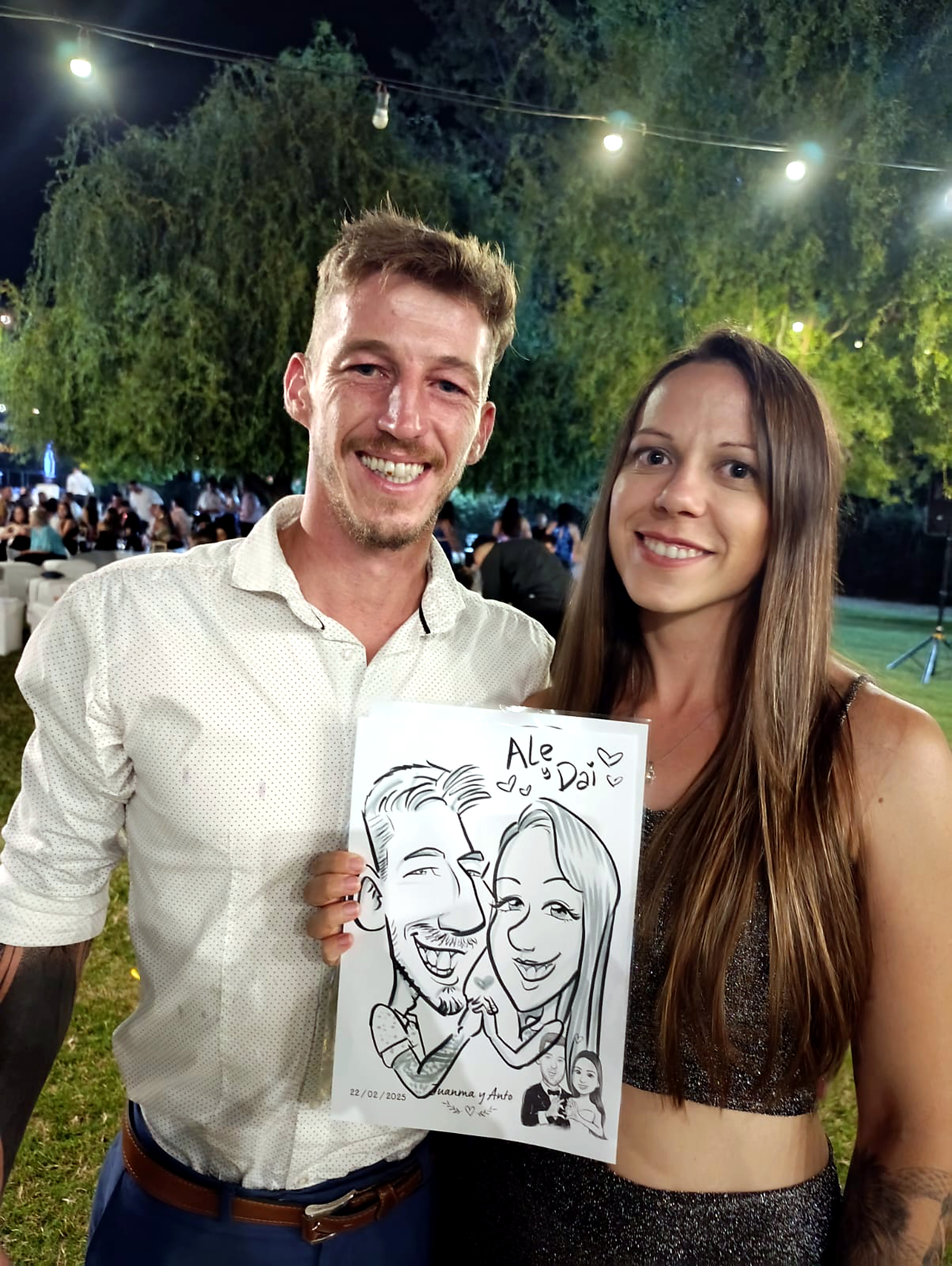 Pareja mostrando la caricatura recibida en su evento